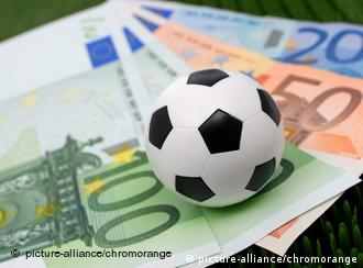 Symbolic picture: soccer ball and money